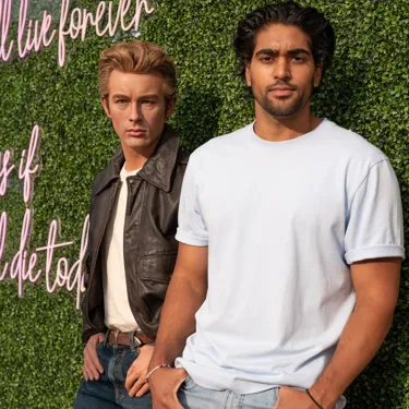 Man posing with James Dean wax figure